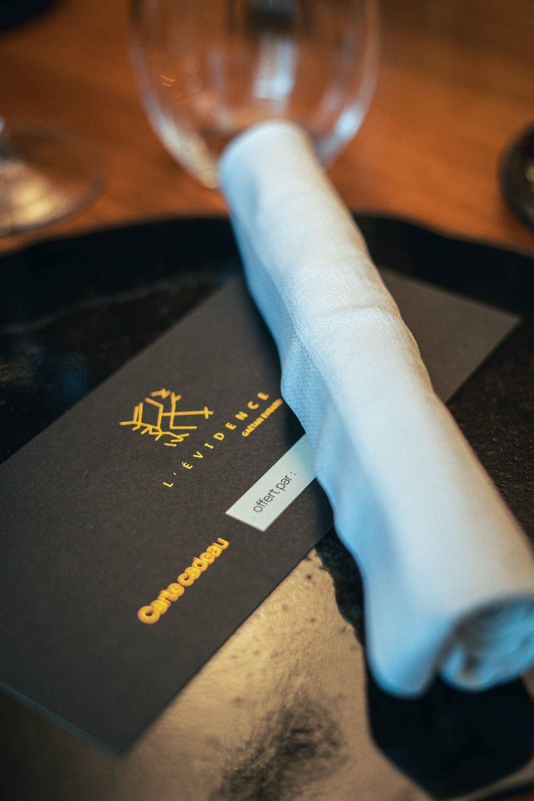 Carte cadeau L’Évidence posée sur une table dressée